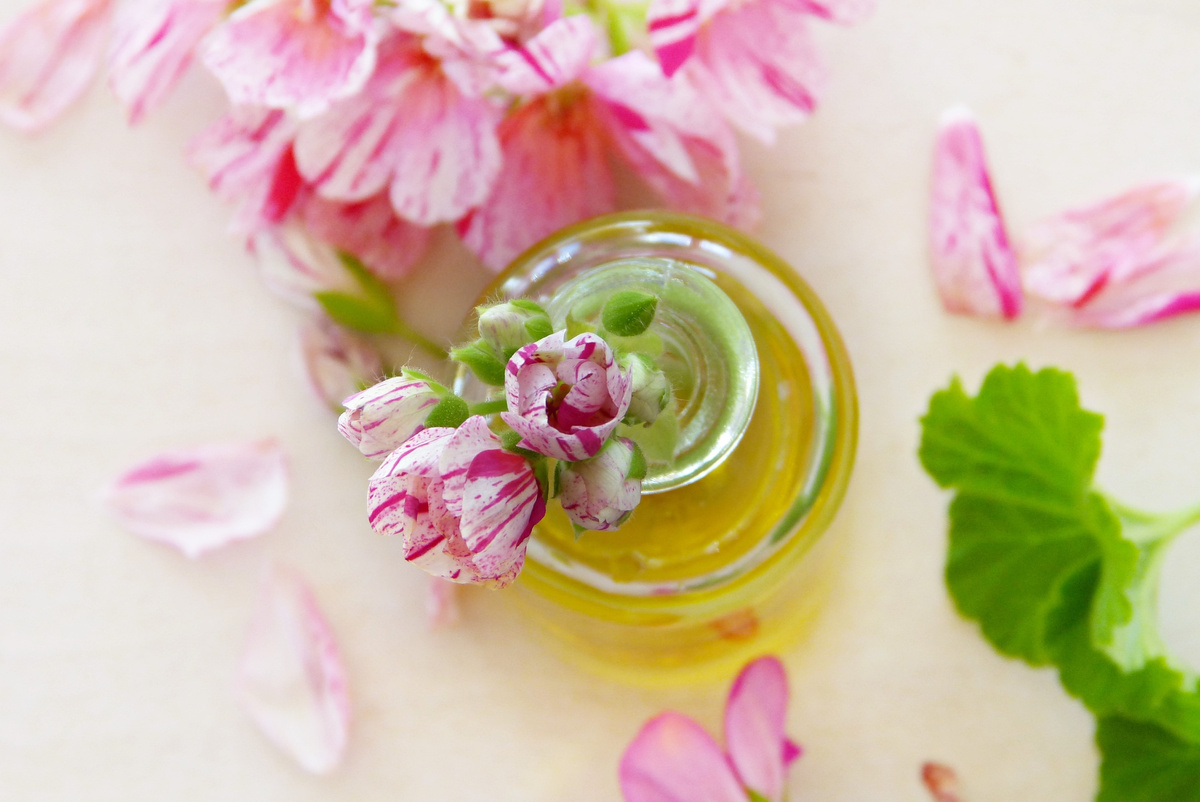 Top View Of Essential Oil And Flowers